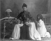 Mother praying with her children