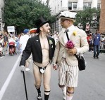 A couple march dressed as bride and groom during the Gay Pride Parade in New York
