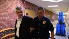 Mr. Baer handcuffed and under arrest.